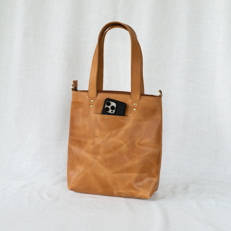 Functional bucket bag tote showcasing its ability to hold essentials and a laptop comfortably.