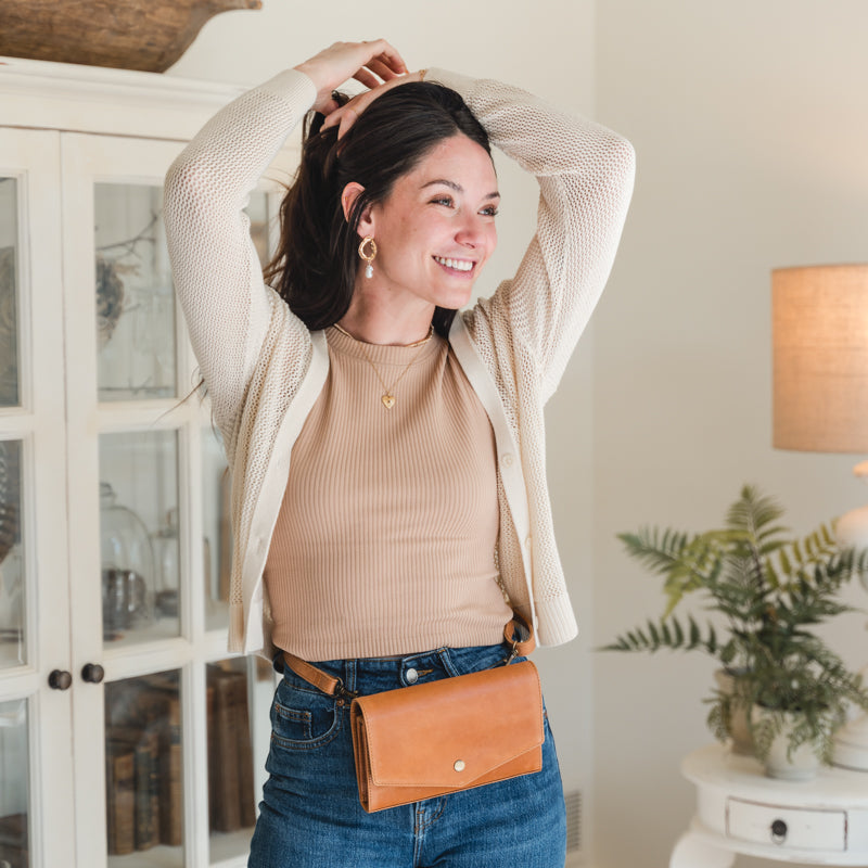 Joyful model showcasing the DiMarco Crossbody Bag with Wallet in tan, highlighting its trendy versatility.