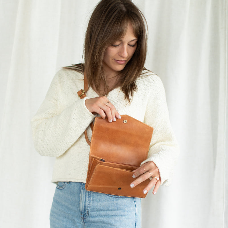 Model holding the DiMarco Crossbody Bag with Wallet in tan, showing its stylish versatility for any occasion.