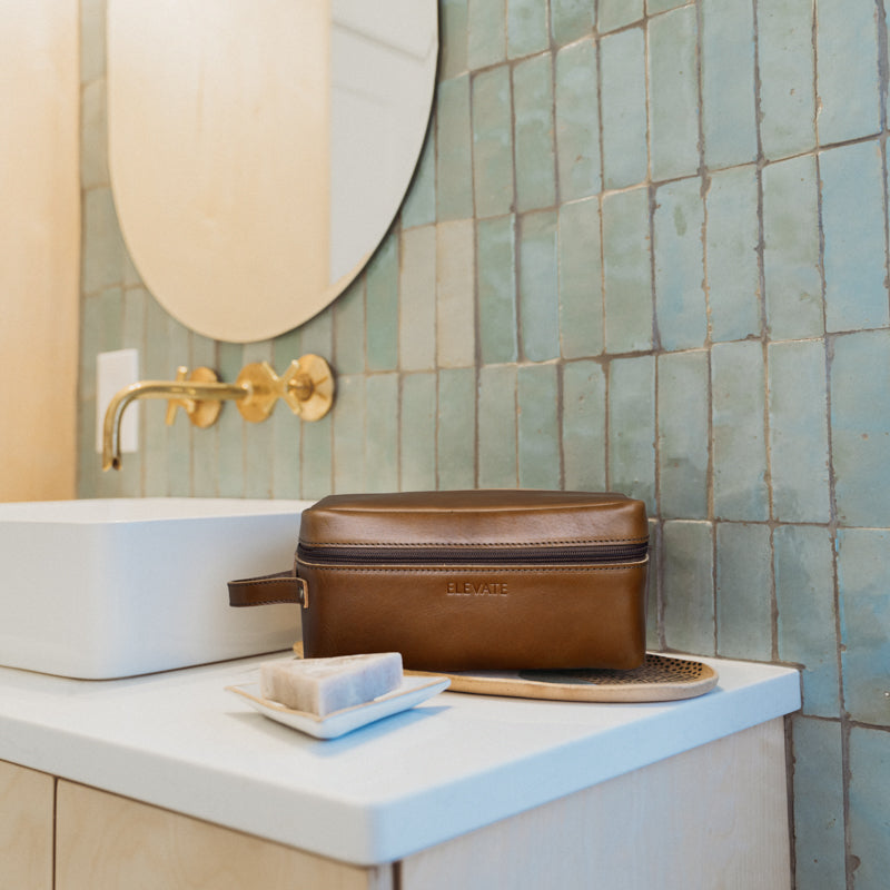 Close-up of the secure zipper pocket in the full-grain leather dopp kit for safe storage.