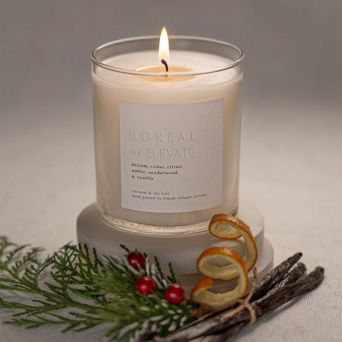 Lit Boreal Holiday Candle With Balsam, creating a relaxed ambiance, perfect choice for a holiday candle with balsam during celebrations.
