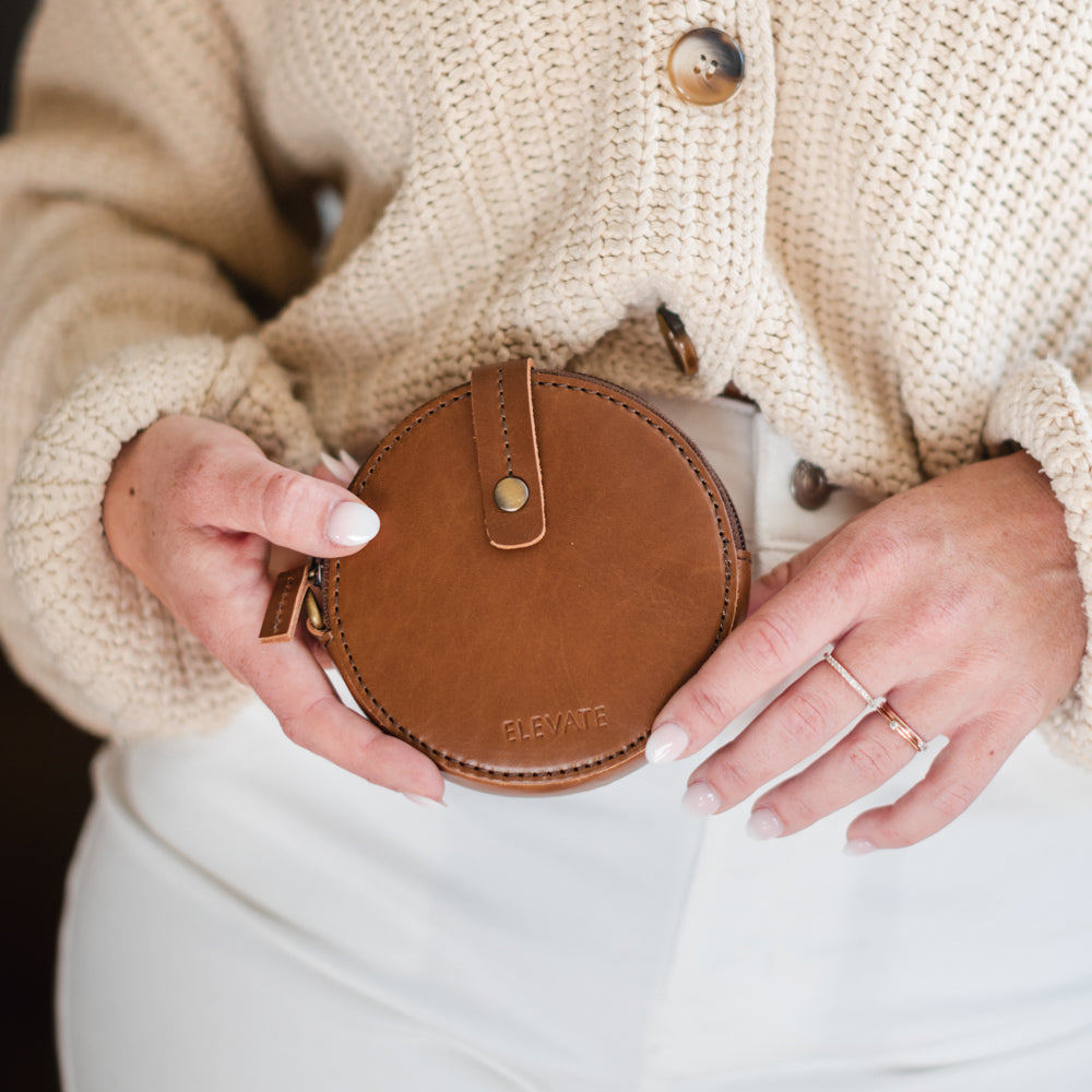 Compact leather coin purse highlighting its versatility for organizing cash and cards.