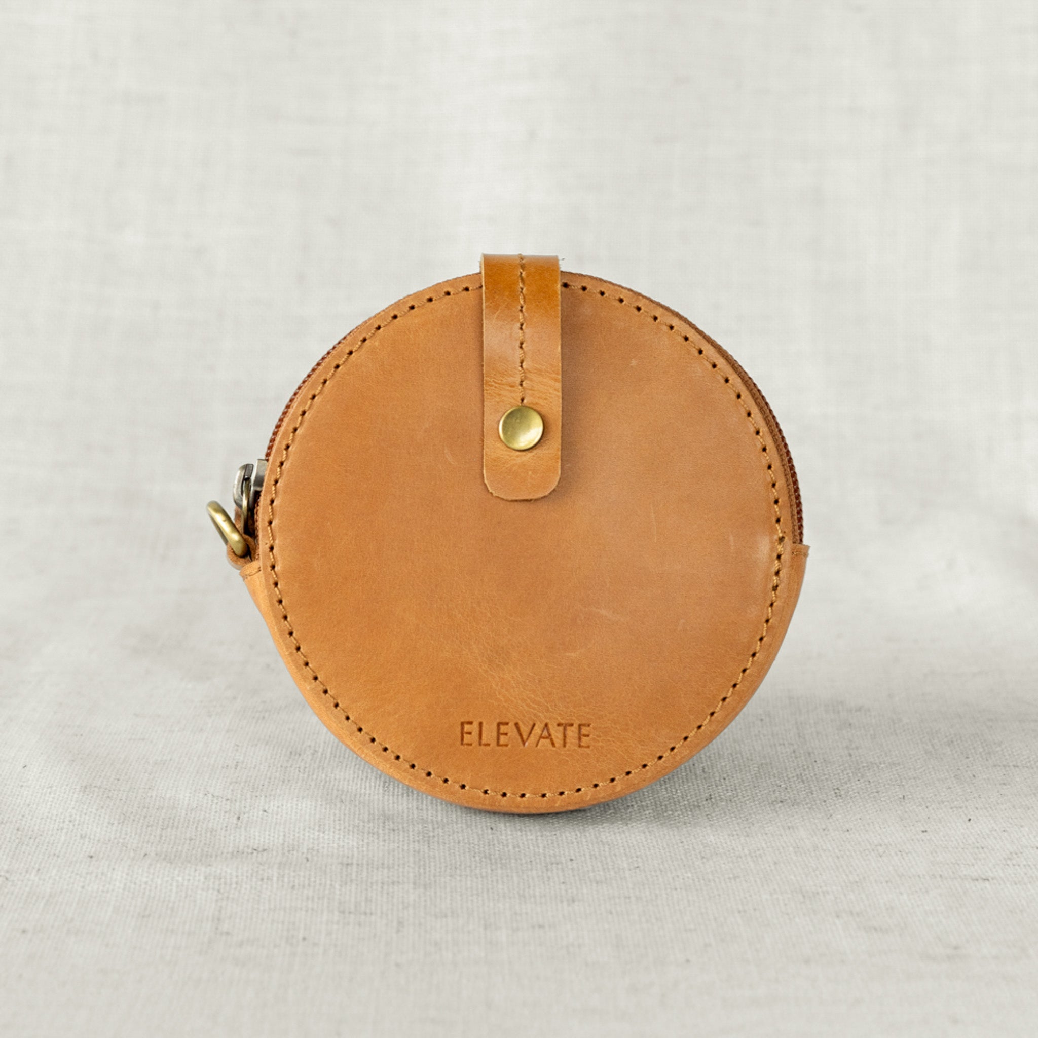 Stylish leather coin purse shown with full-grain leather texture and spacious main compartment.