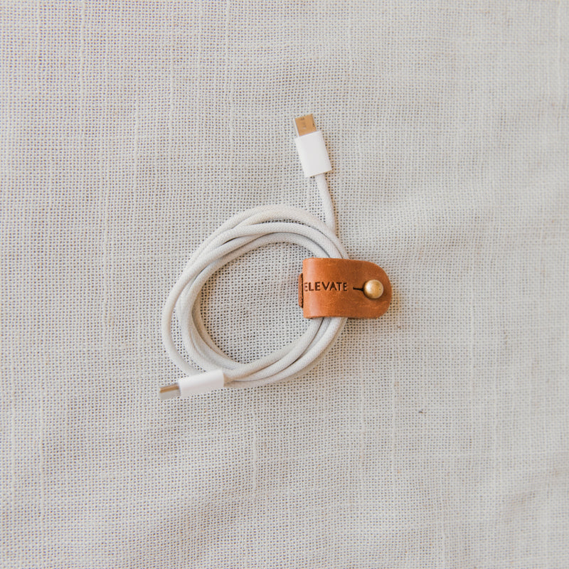 Stylish Leather Cord Wrap Organizer showcasing premium full-grain leather design for tangle-free storage.