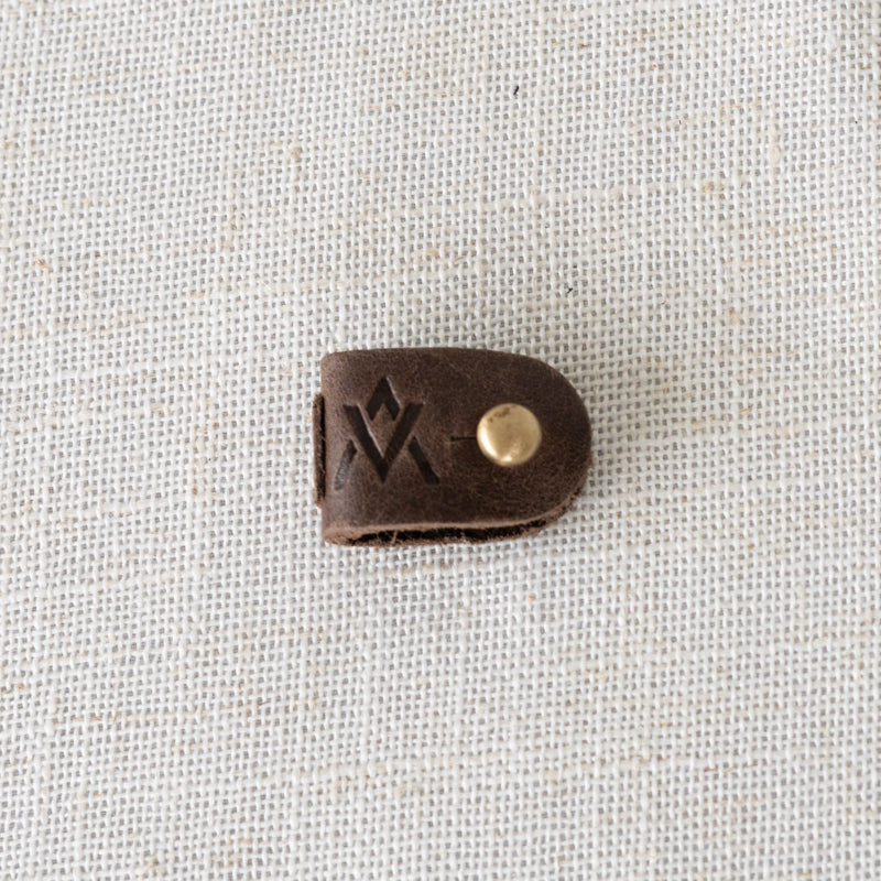 Close-up of Leather Cord Wrap Organizer featuring durable, high-quality leather perfect for organized cable storage.