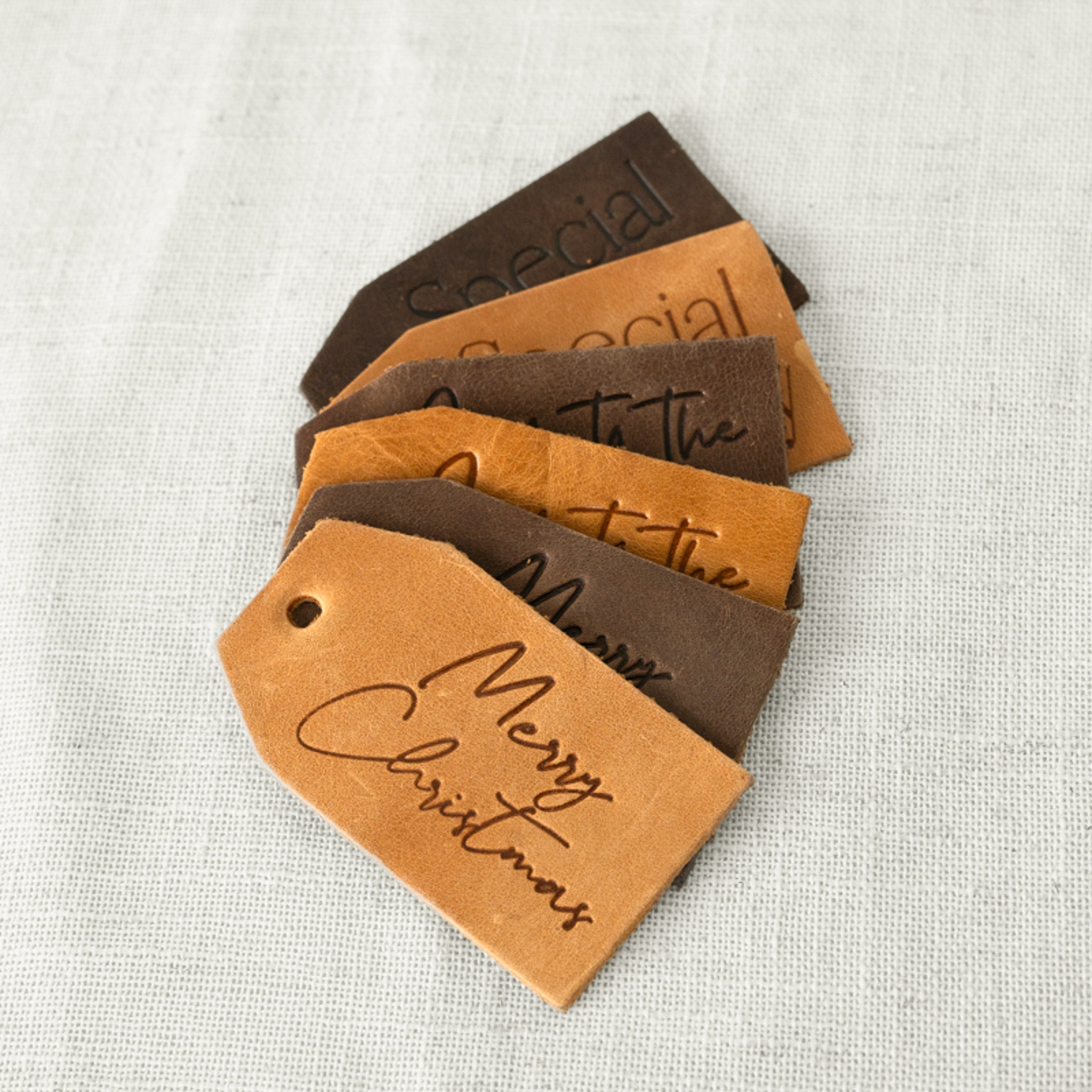 Leather Gift Tags beautifully displayed in a holiday setting, showcasing stylish designs that enhance your gift wrapping.