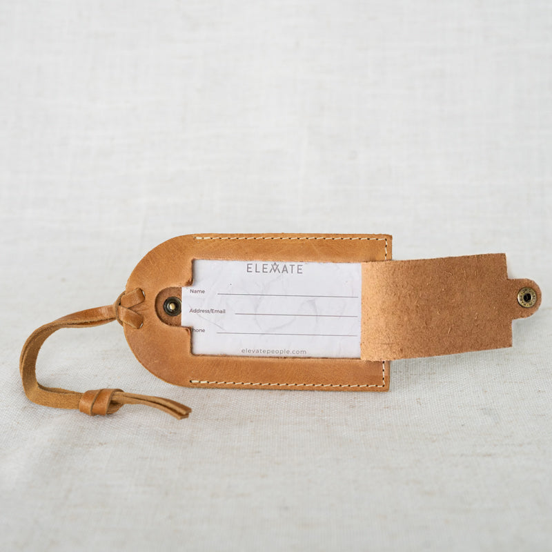 Close-up view of a durable leather luggage tag showcasing its craftsmanship and elegant design.