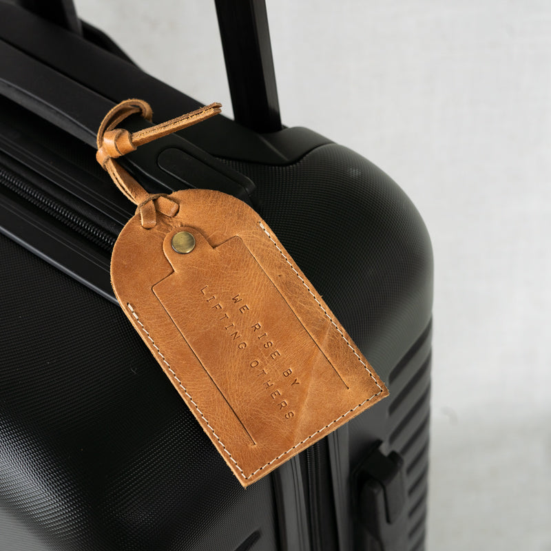 Artisan-made leather luggage tag in an attractive setting, ideal for jet-setters and adventurers.