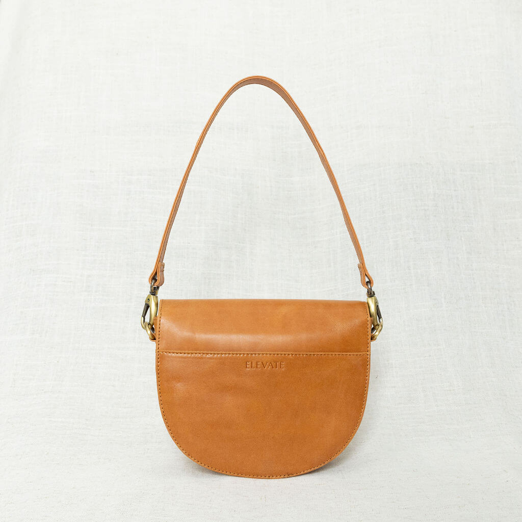 Stylish Stella Saddle Bag featuring a casual look with woven crossbody straps, a trendy leather saddle bag.