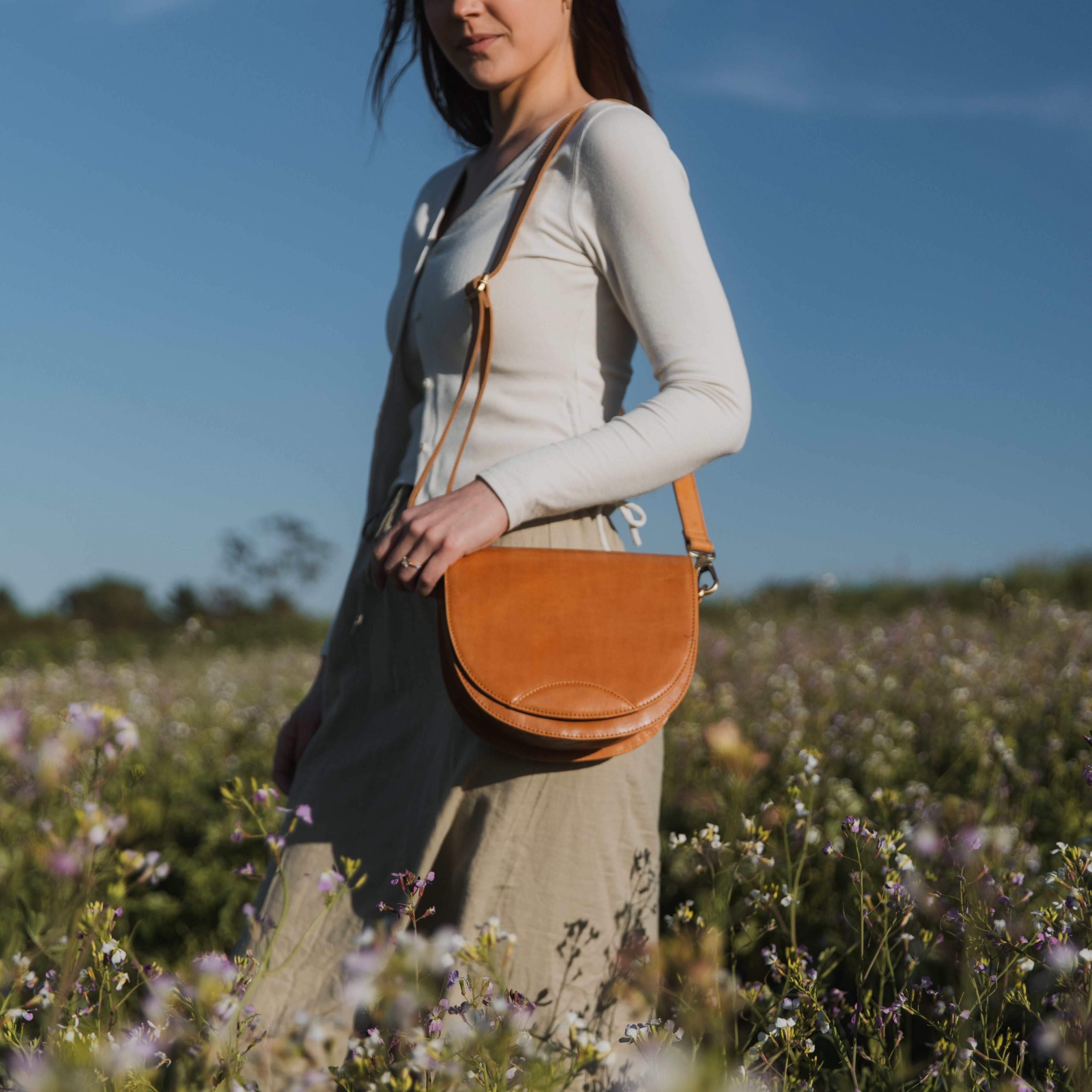 Close-up of the Stella Saddle Bag showcasing its beautiful leather texture and smart storage features.