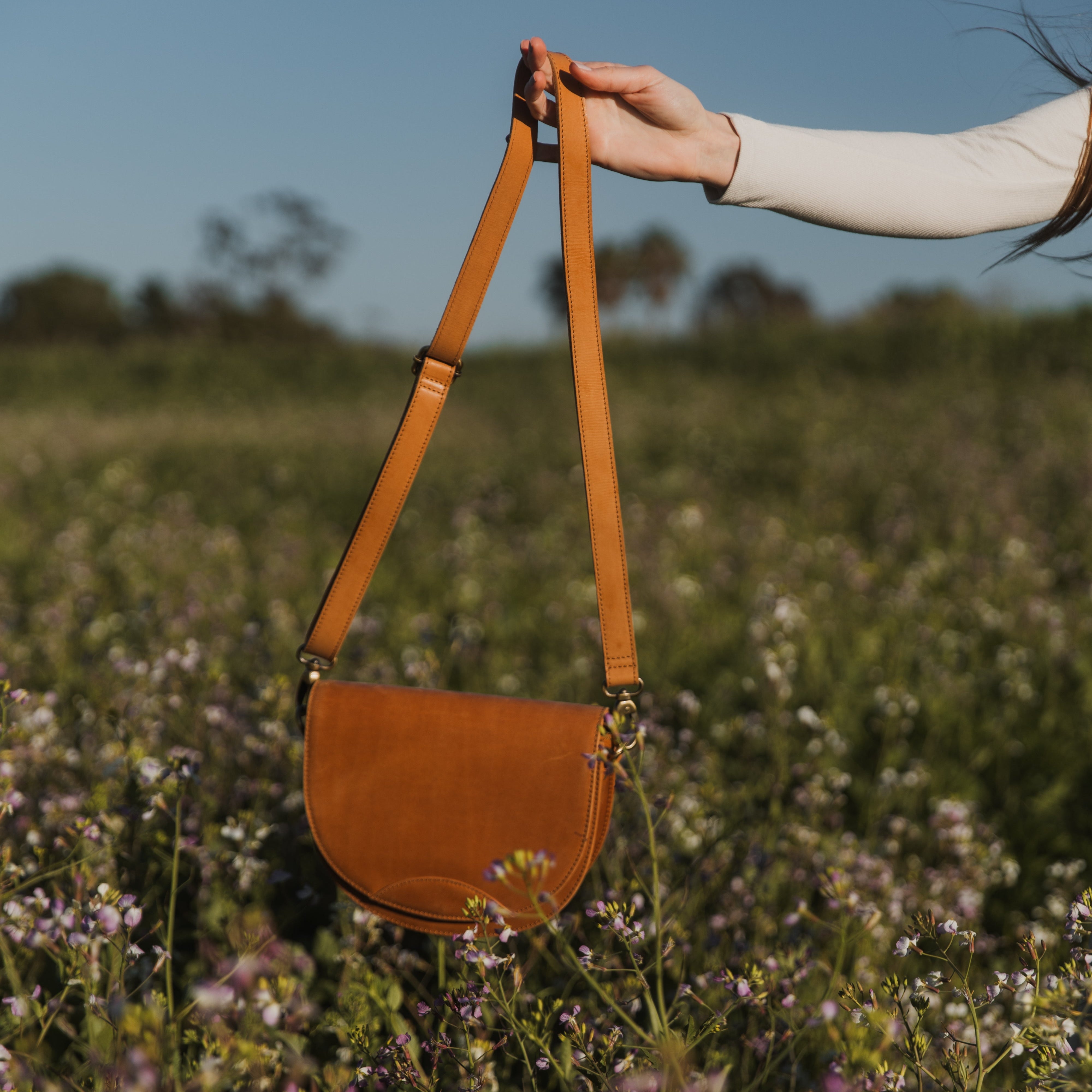 Stella Saddle Bag displayed with matching leather strap, a versatile leather saddle bag for every occasion.