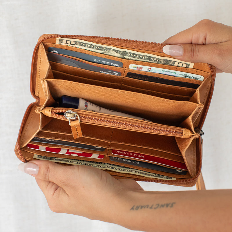 Close-up of the spacious interior of the leather zipper wallet, showcasing card slots and a phone compartment.