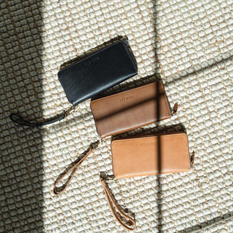 A stylish person using the leather zipper wallet in a daily setting, highlighting its functionality and design.
