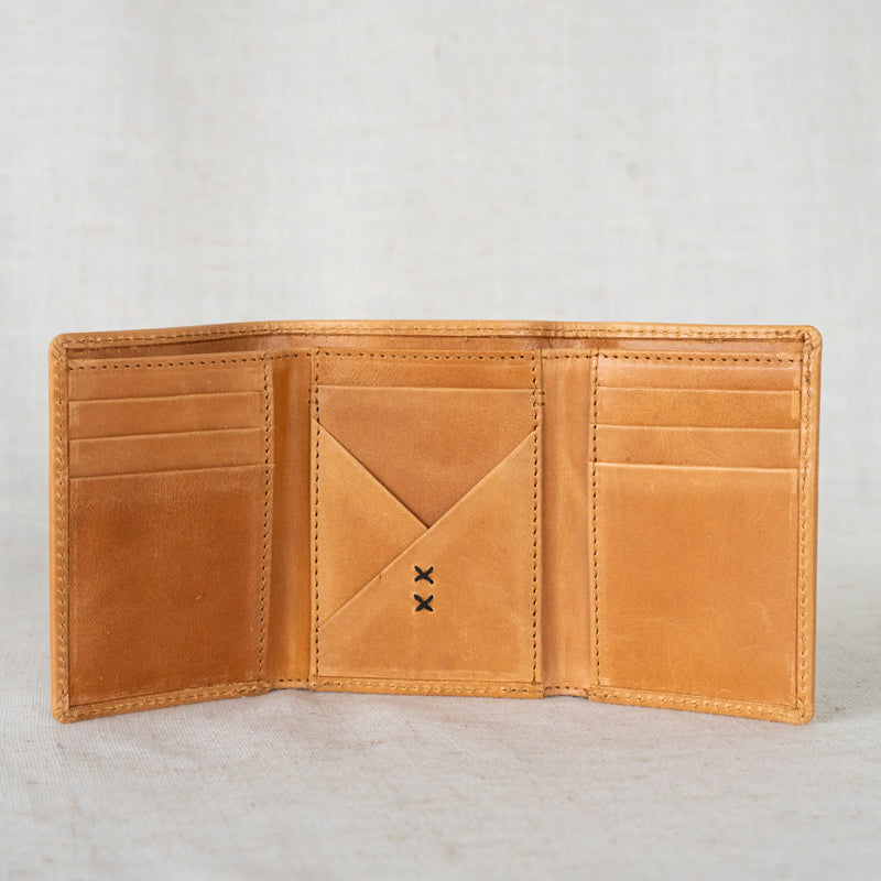 Lifestyle shot of the Titus Mens Leather Tri-Fold Wallet in a casual setting, perfect for any occasion.