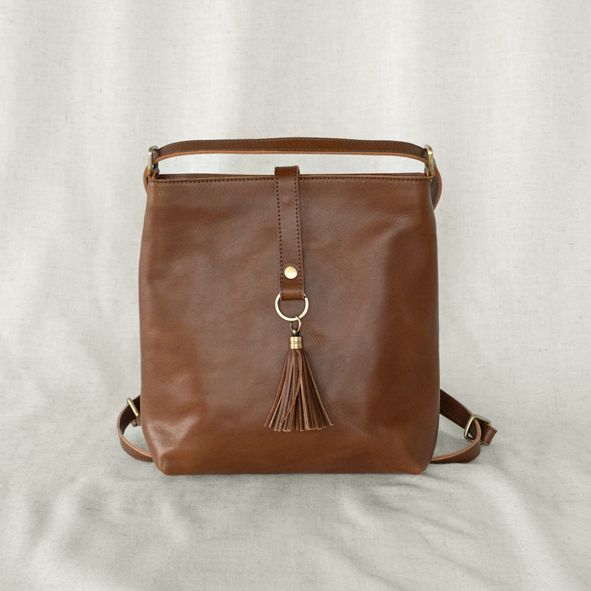 Elevate Mini Slingback Bag flat lay showing the spacious interior and adjustable straps, perfect features of the mini slingback bag.