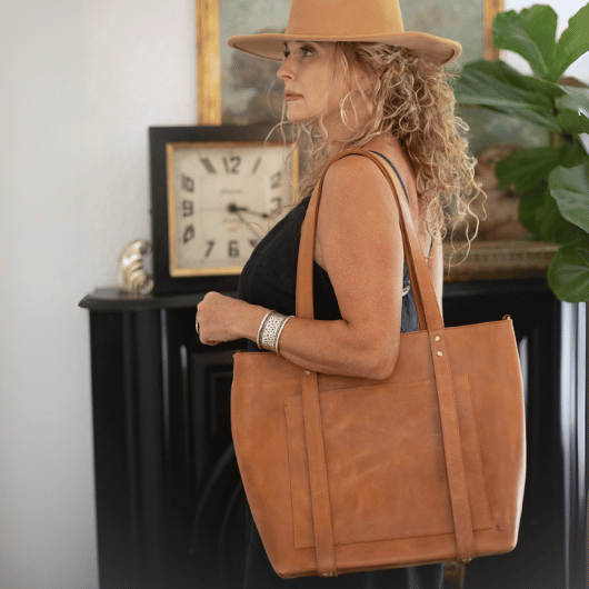 Versatile Leather Travel Hat Tote - Highlighting its detachable crossbody strap for hands-free carrying.