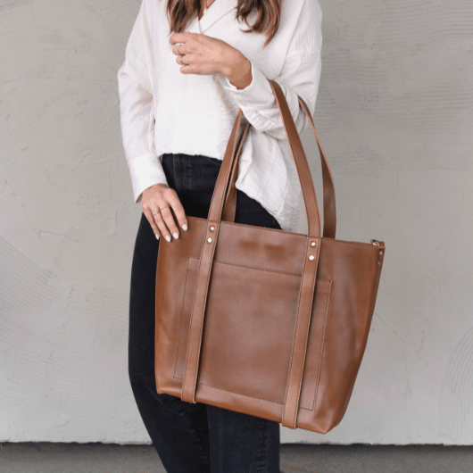 Leather Travel Hat Tote in use, elegantly showcasing its versatile carrying options for modern-day travelers.