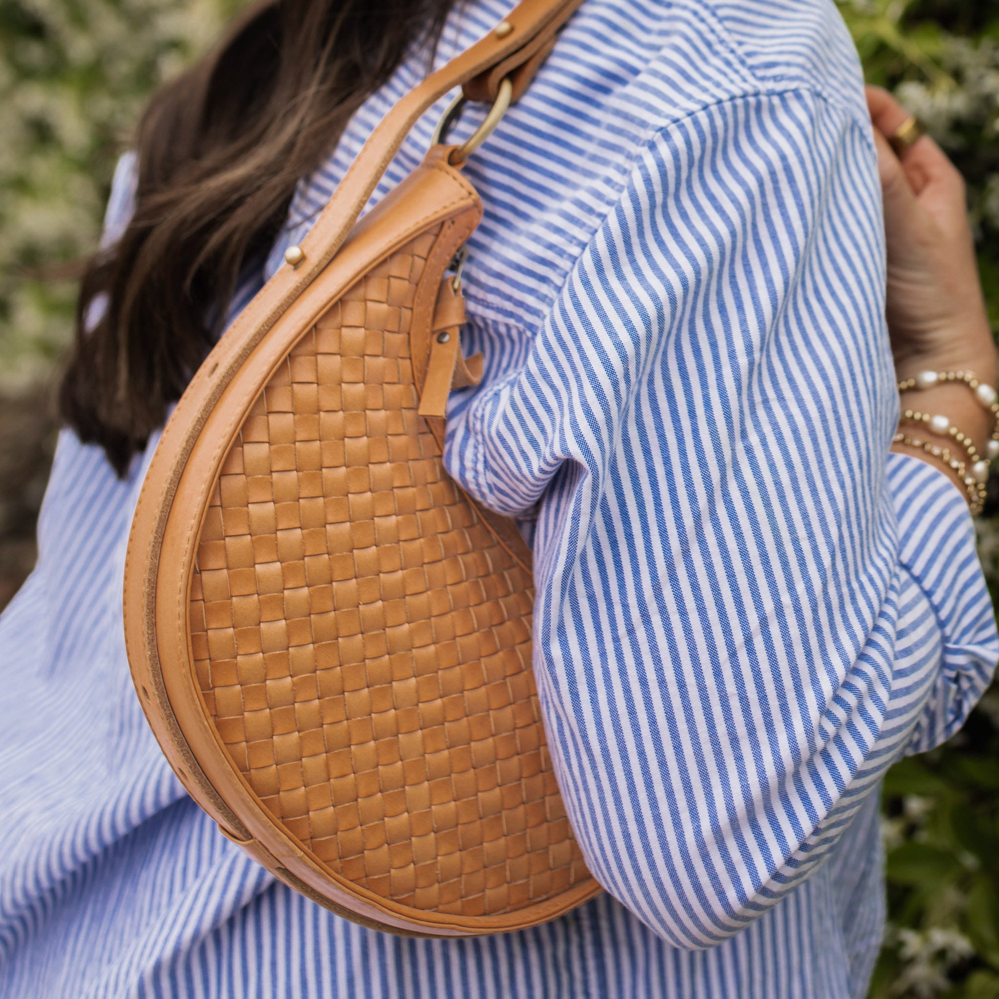 Adjustable 3-in-1 convertible strap on Priya woven leather crossbody