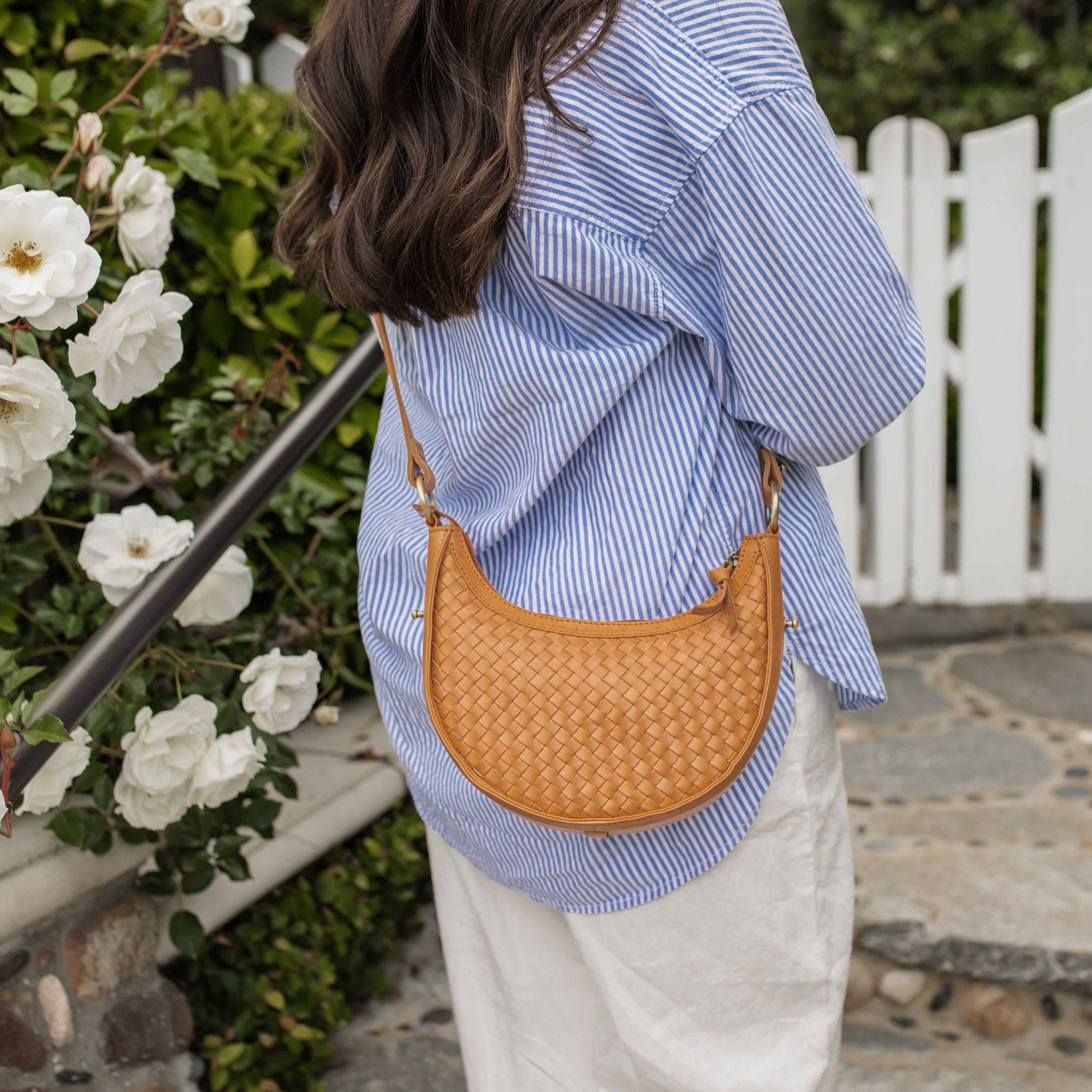 Side profile of Priya crescent-shaped woven leather crossbody purse