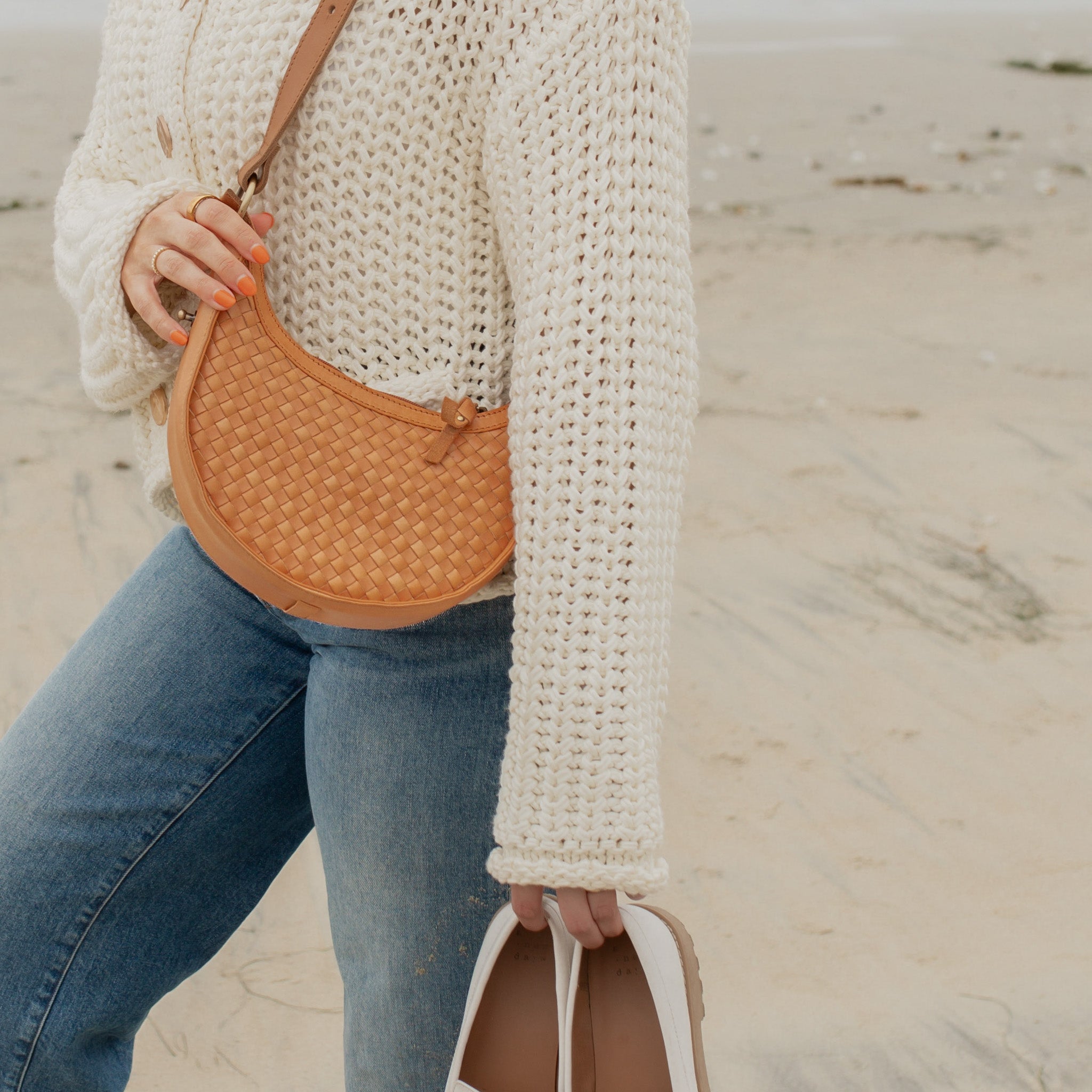 Priya woven leather crescent crossbody styled with casual outfit