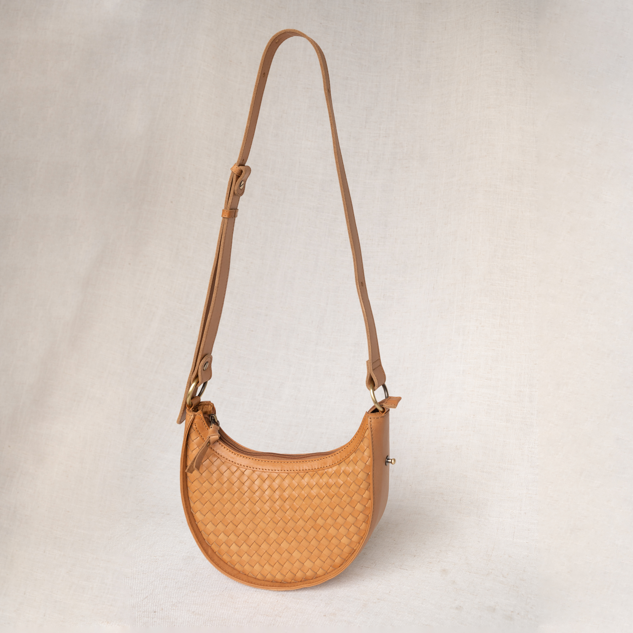 Adjustable 3-in-1 convertible strap on Priya woven leather crossbody
