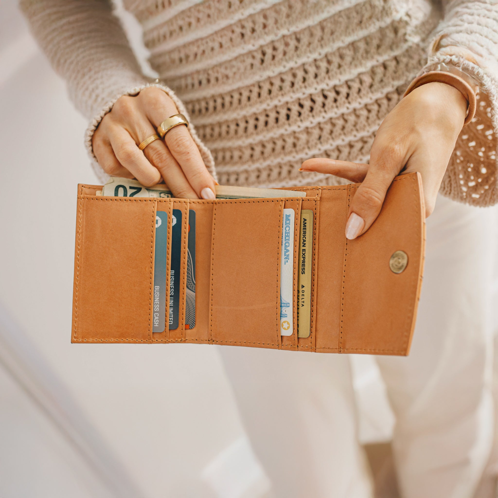 Detail view of Suri Woven Leather Wallet's magnetic closure and sleek profile.