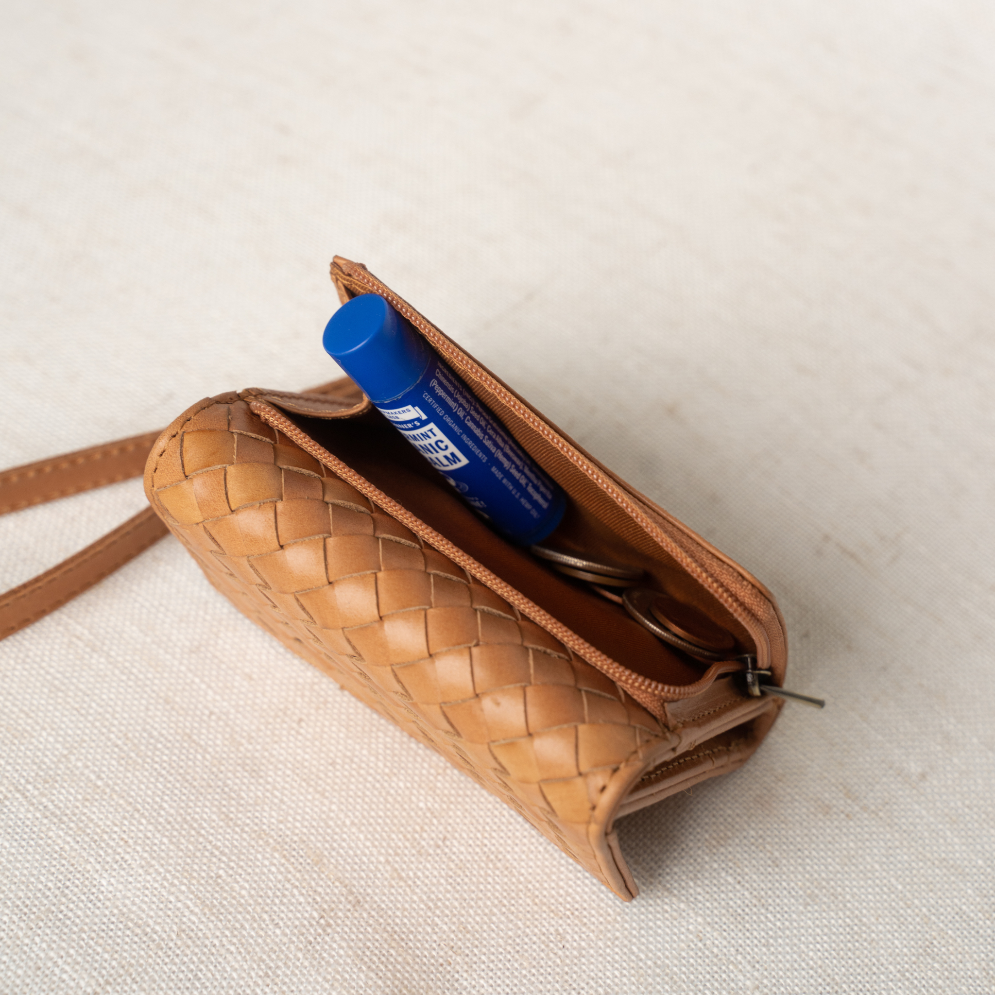Suri Woven Leather Wallet displayed with removable wristlet for hands-free convenience.