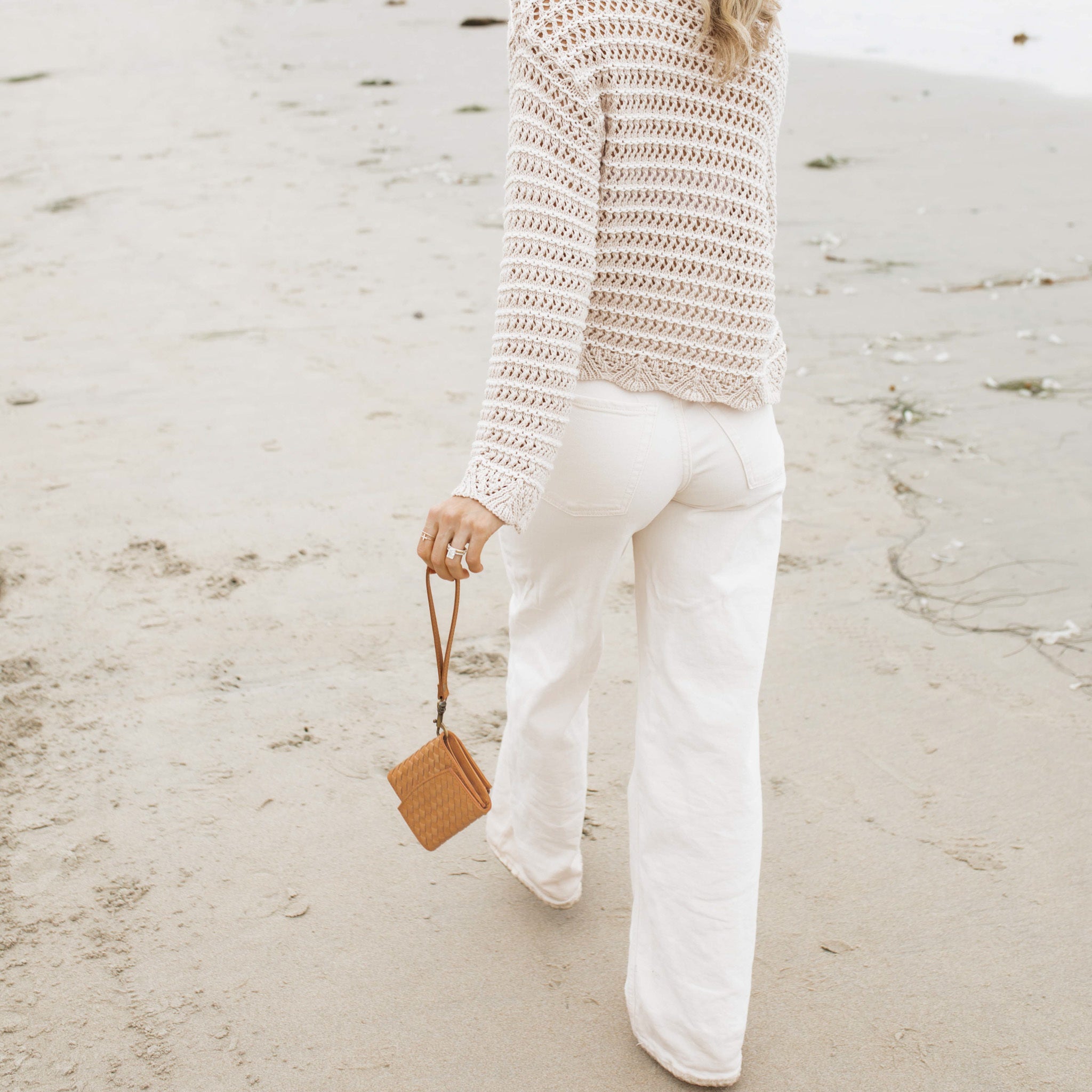 Suri Woven Leather Wallet on a table, emphasizing its elegant and timeless design.