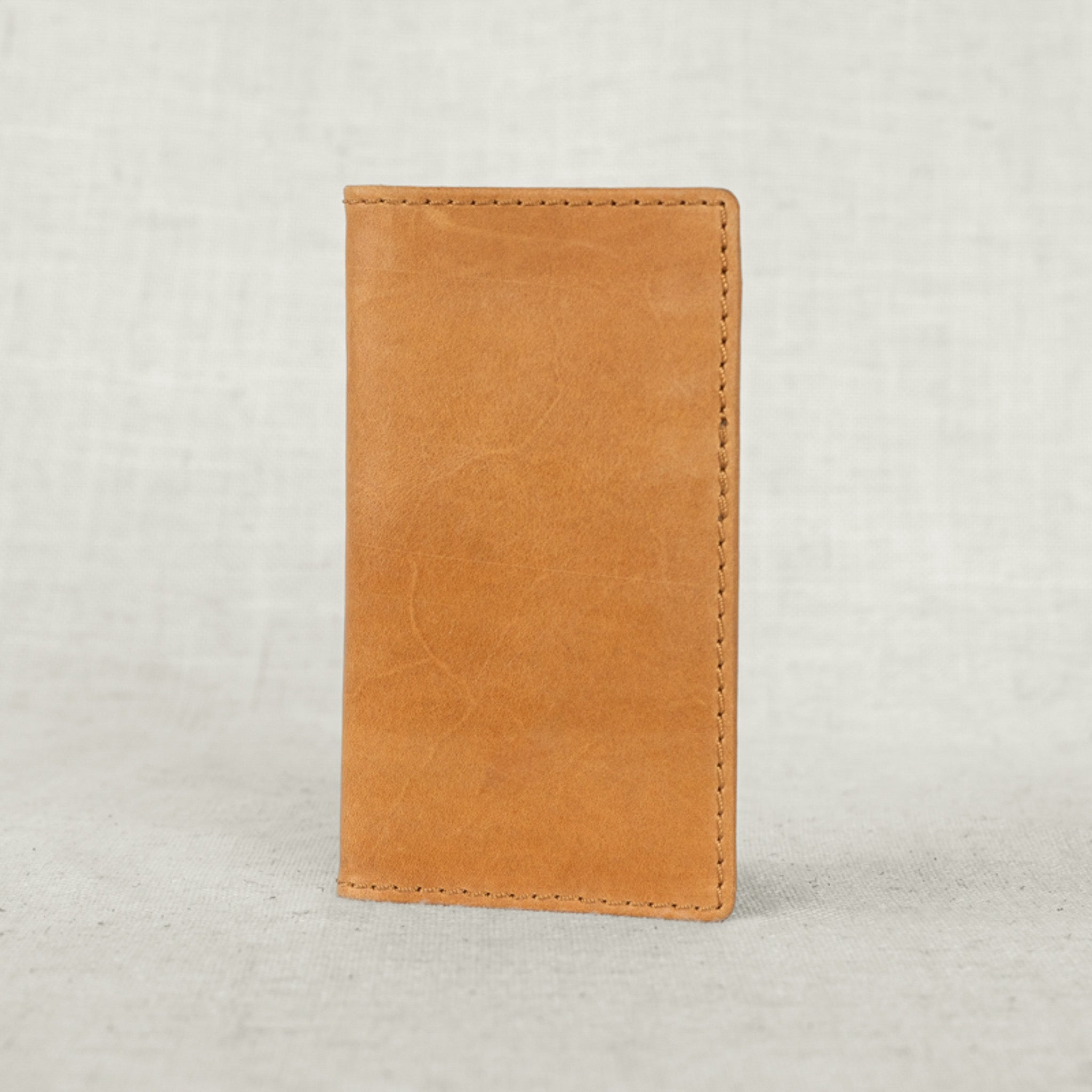 Stylish Vertical Leather Wallet open with cards and cash, demonstrating practical usage.
