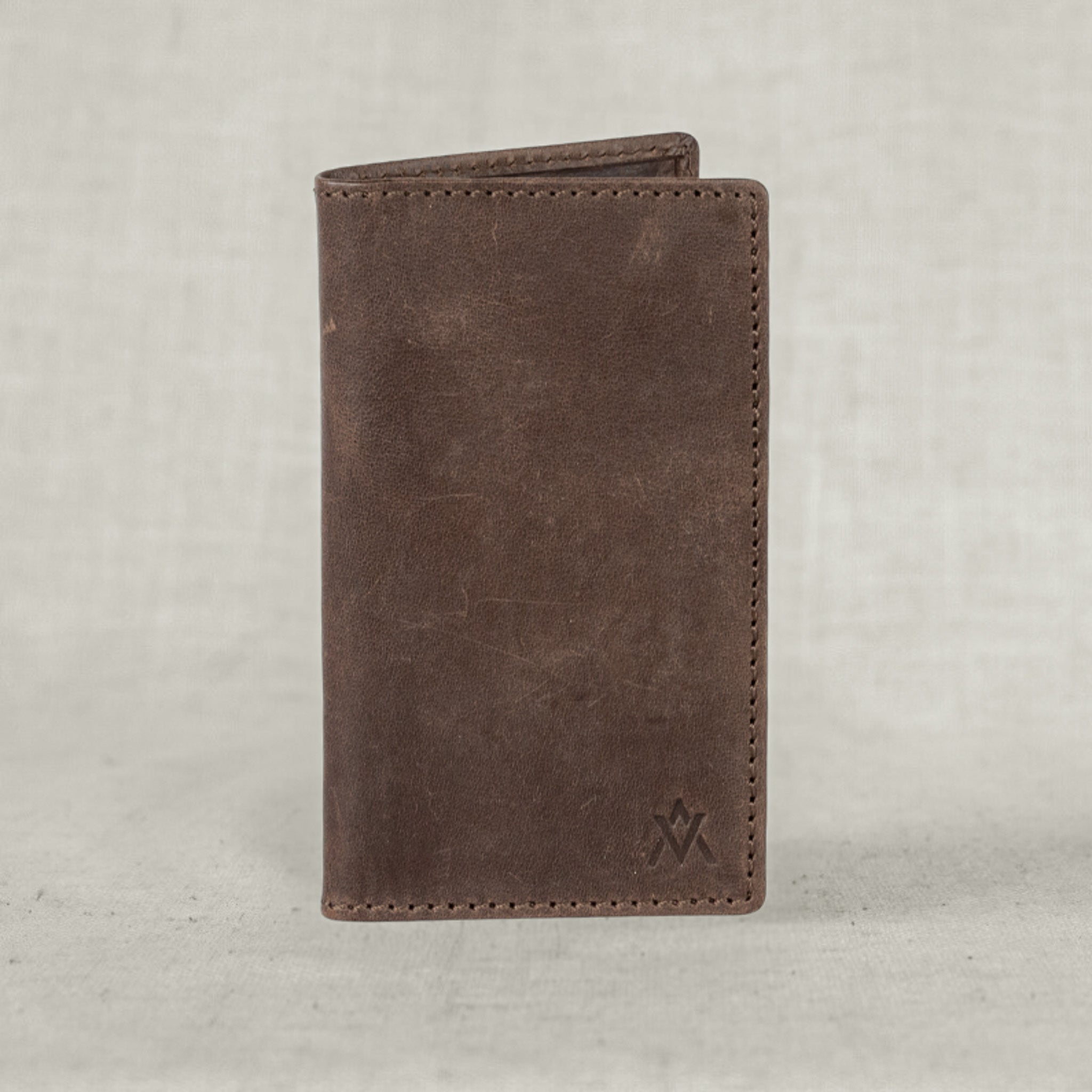Lifestyle image of the Vertical Leather Wallet in a hand, perfect for on-the-go minimalists.