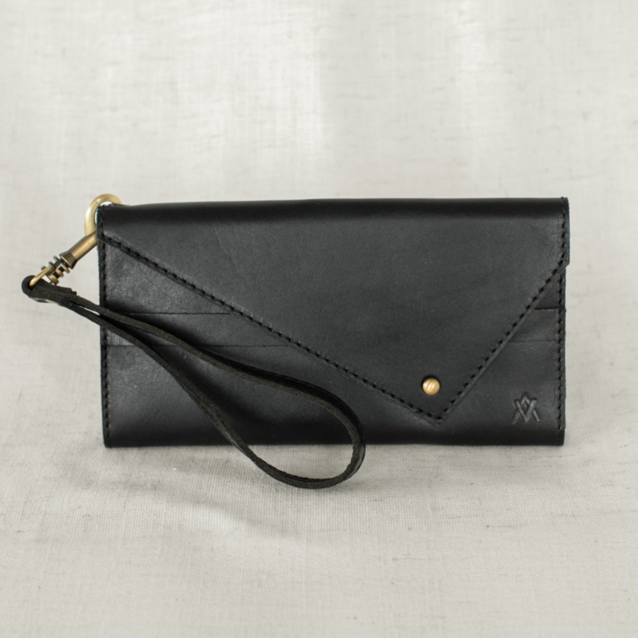 Lifestyle image of a woman carrying the Tri-fold Wallet, demonstrating its chic appeal as a women's leather wallet.