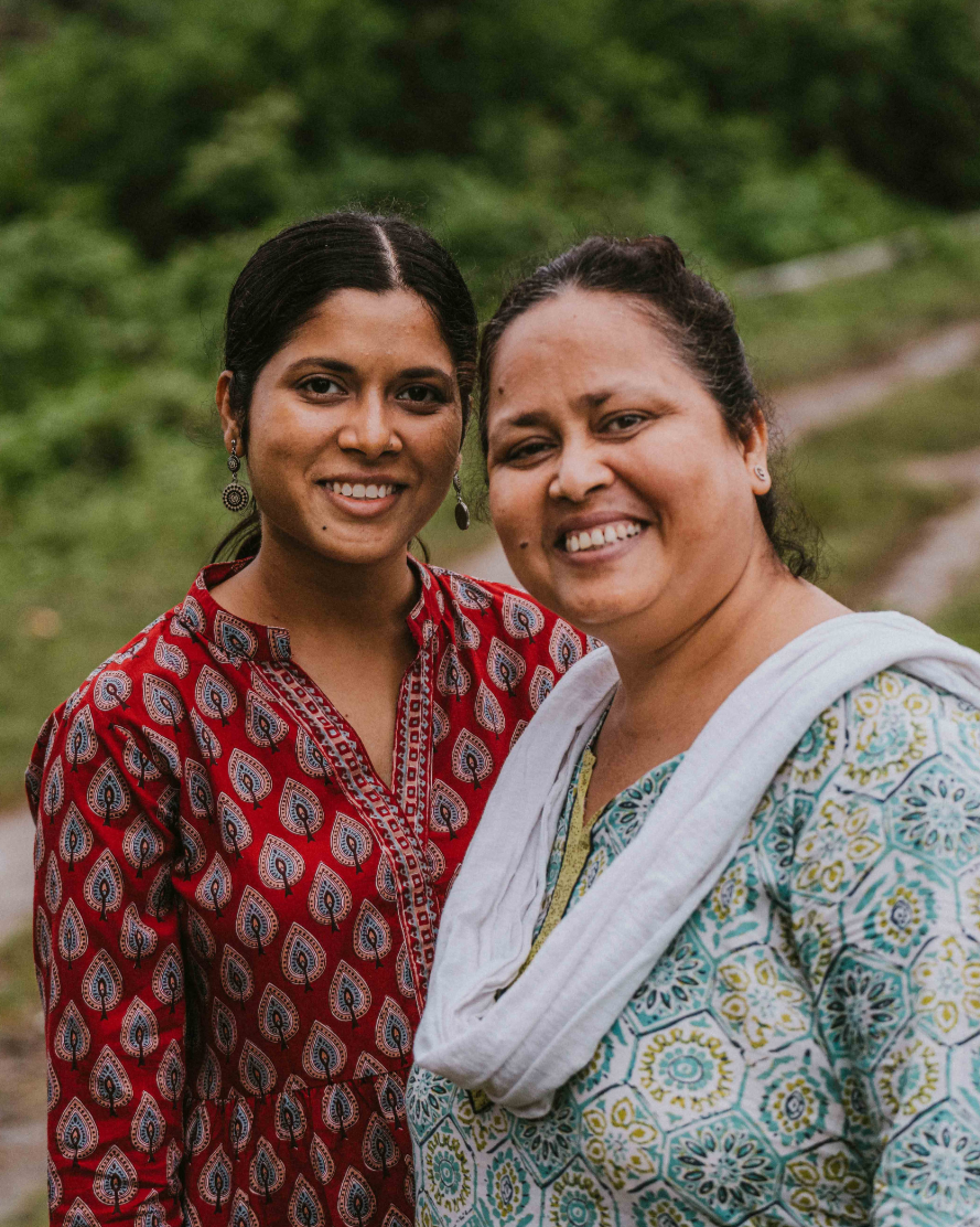 two indian women smiling next to each other