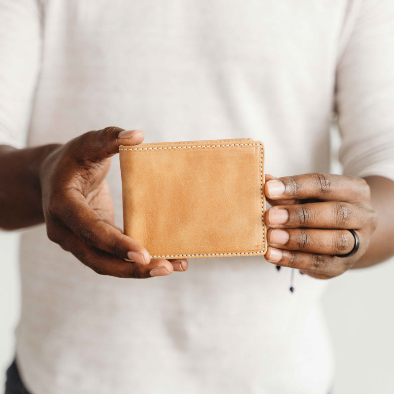 Man holding Elevate bifold wallet