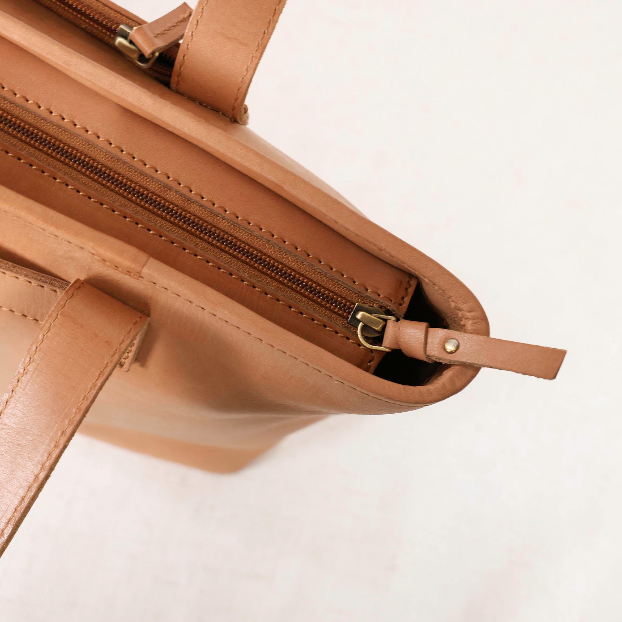 Tara Tote - Premium Leather Tote With Laptop Sleeve carried by a person, demonstrating its chic look.