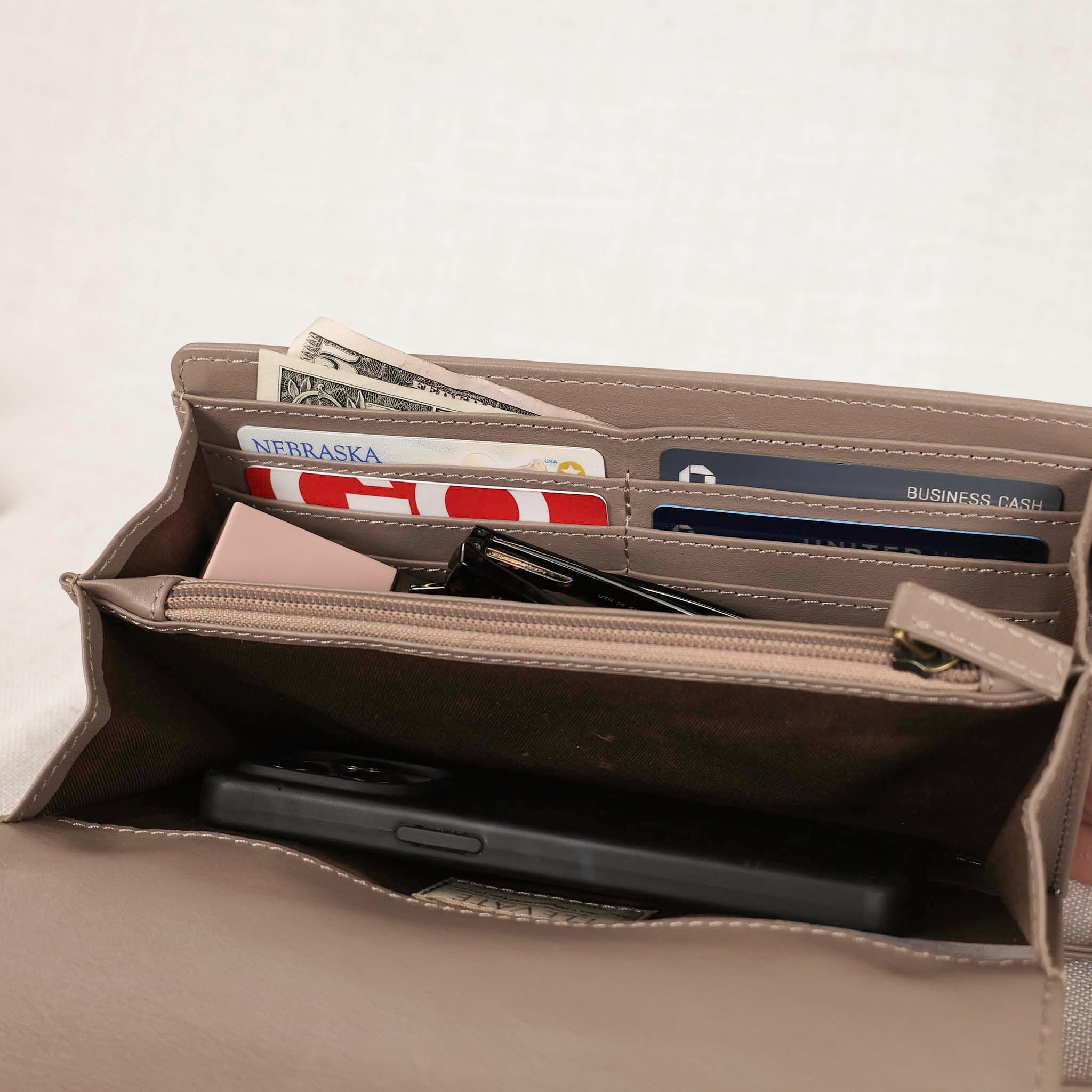 inside view of the dimarco crossbody in taupe color leather