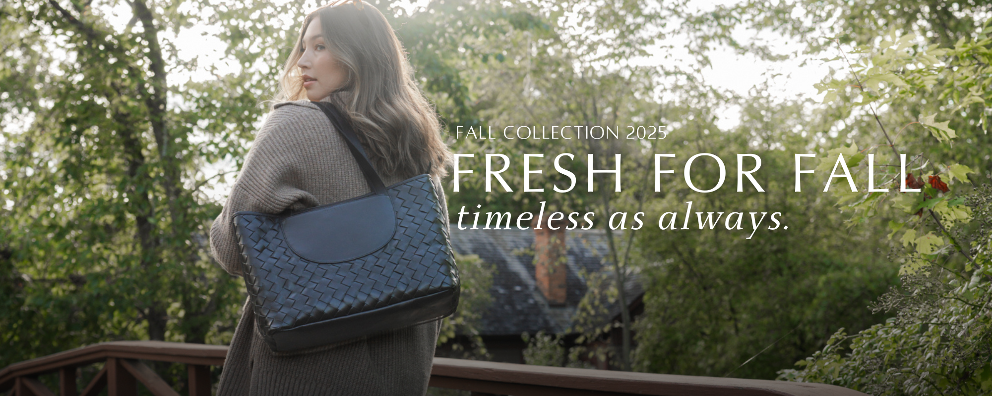 Woman holding a blue handbag with 'Fresh for Fall' text overlay in a forest setting