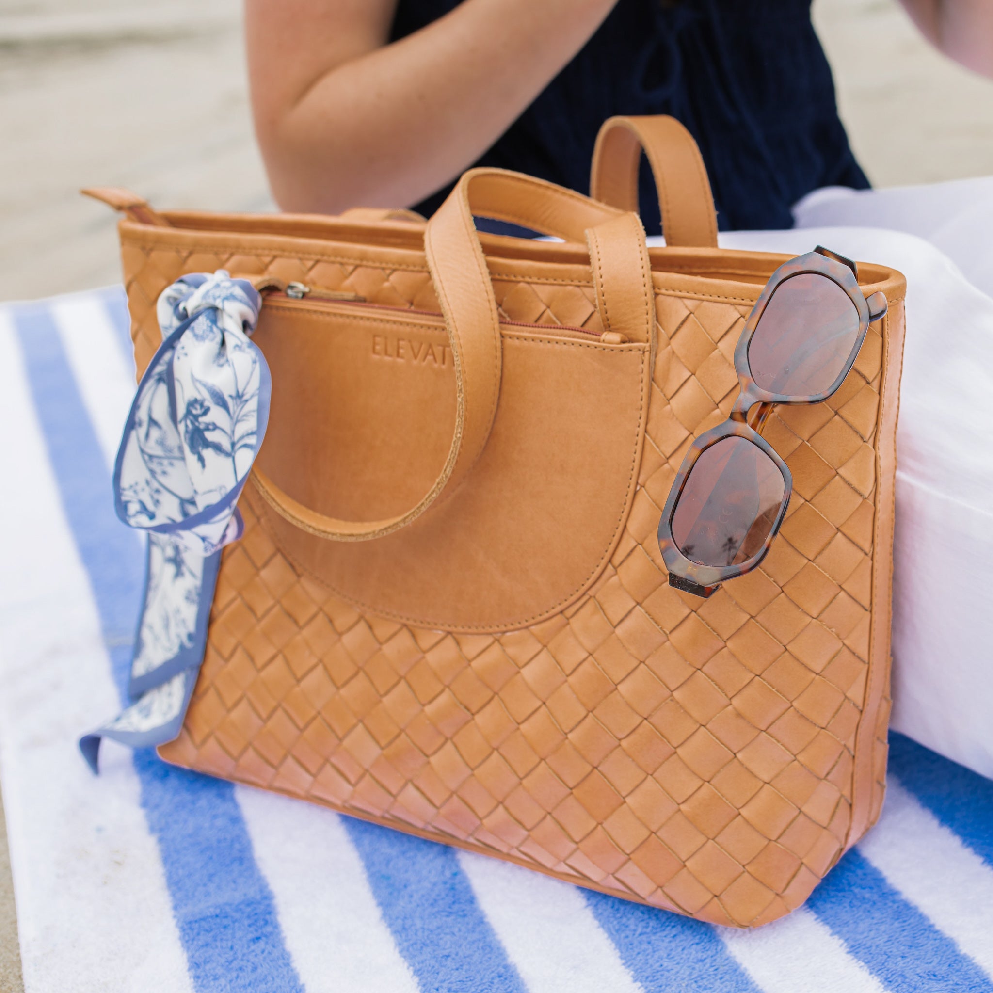 Tara Tote displayed with sleek laptop pocket, highlighting its functionality as a hand woven leather tote.