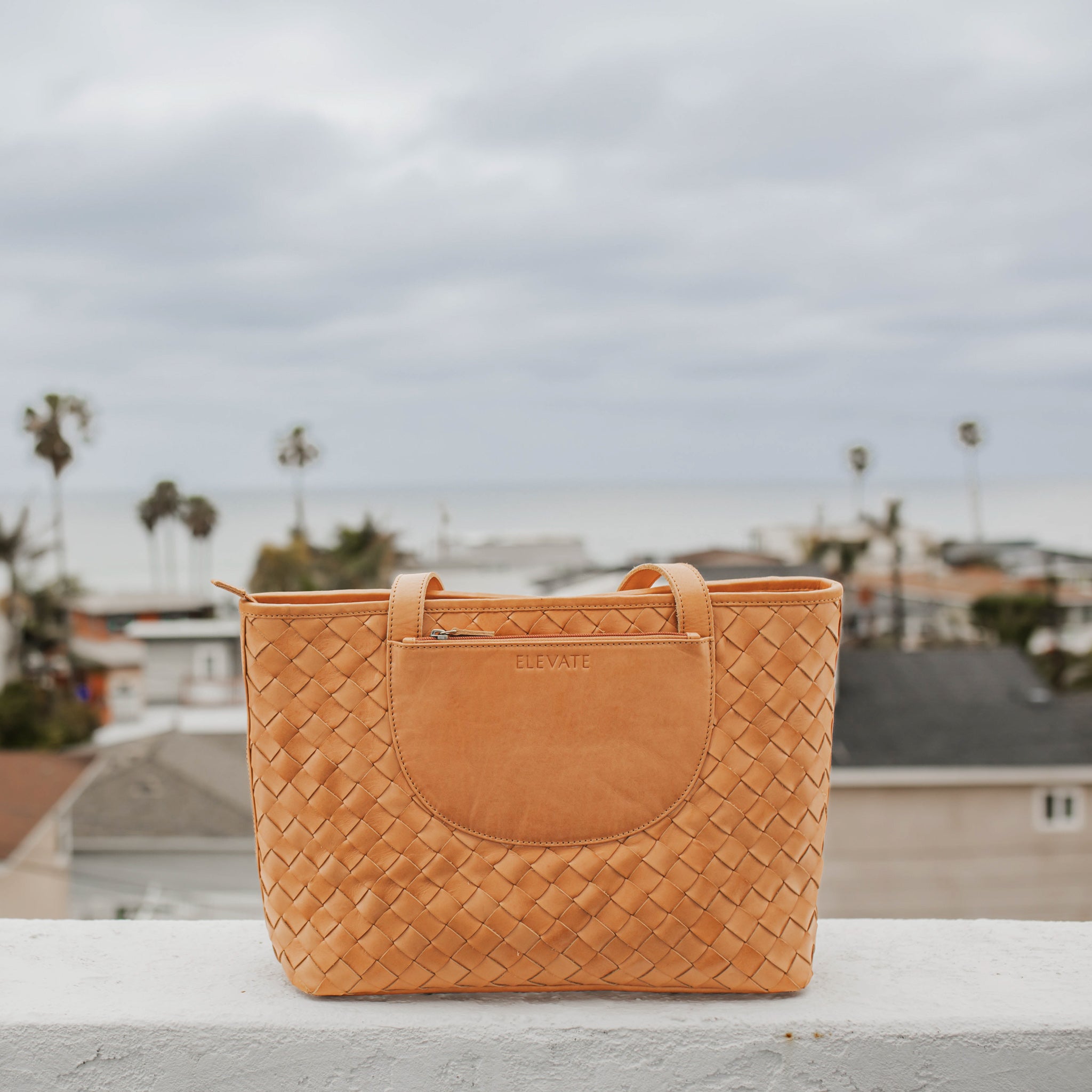 Elegant side view of the Tara Tote, a hand woven leather tote perfect for everyday use.