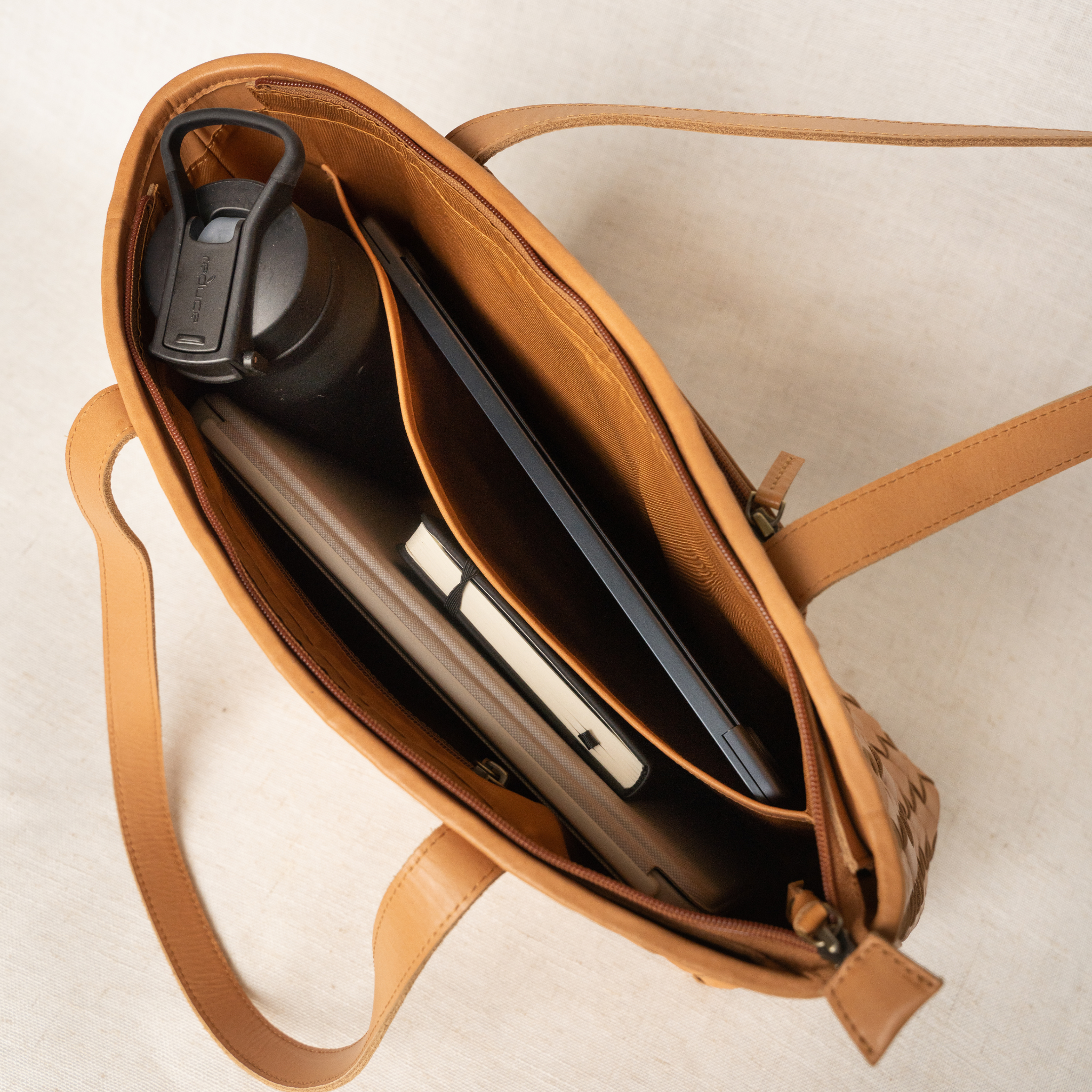 Lifestyle image of the Tara Tote, a versatile hand woven leather tote perfect for work and weekend outings.