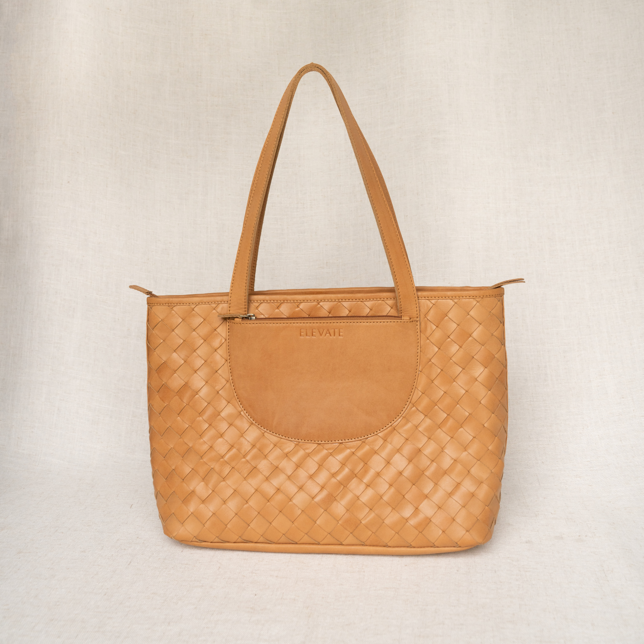 Stunning Tara Tote, a hand woven leather tote showcasing premium quality and stylish design.