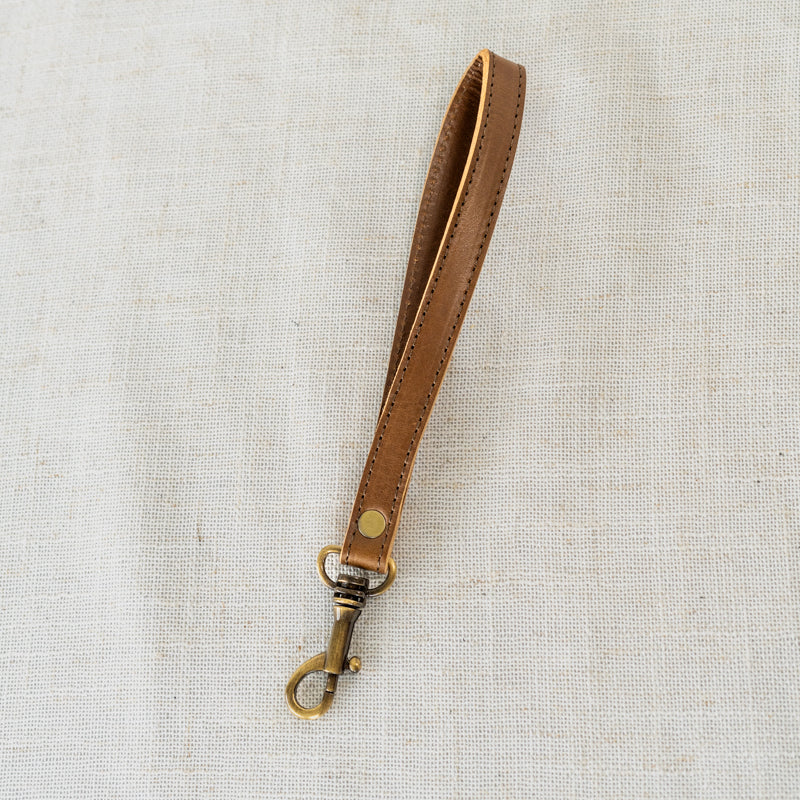 Artisan Craftsmanship of Leather Wristlet - Focus on the meticulous craftsmanship of this handcrafted leather wristlet.