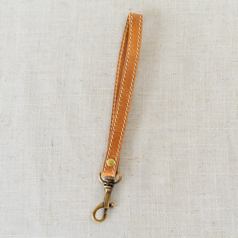 Leather Wristlet with Accessories - Displaying the handcrafted leather wristlet paired with stylish accessories.