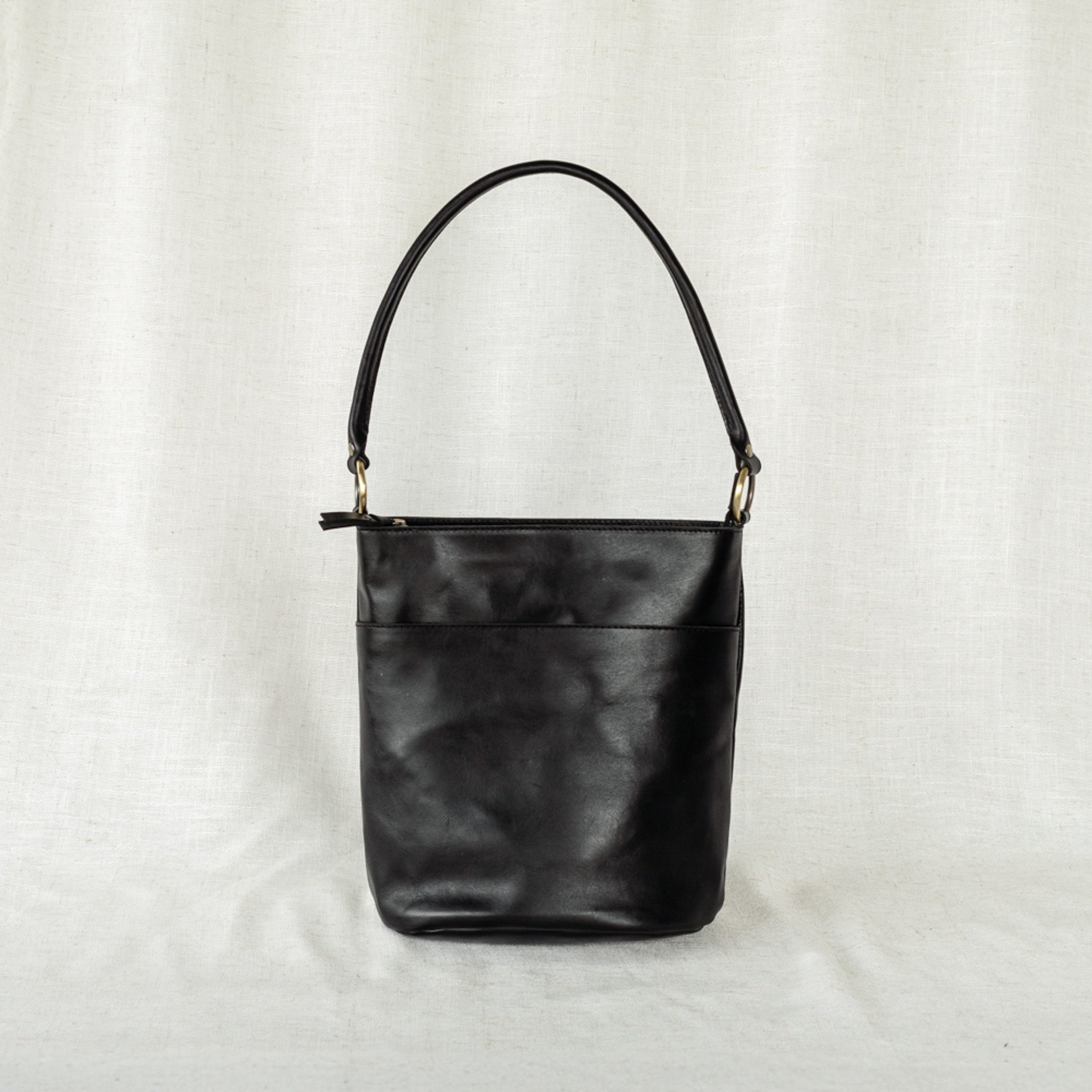 Detailed shot of The Newport Tote’s adjustable strap, featuring a functional leather bucket tote bag design.