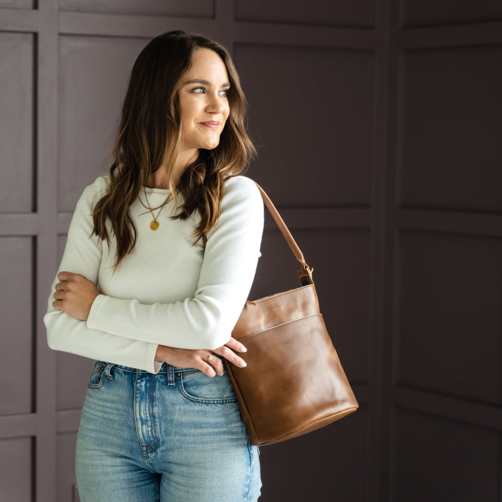 Various styles of The Newport Tote displayed, emphasizing its appeal as a go-to leather bucket tote bag.