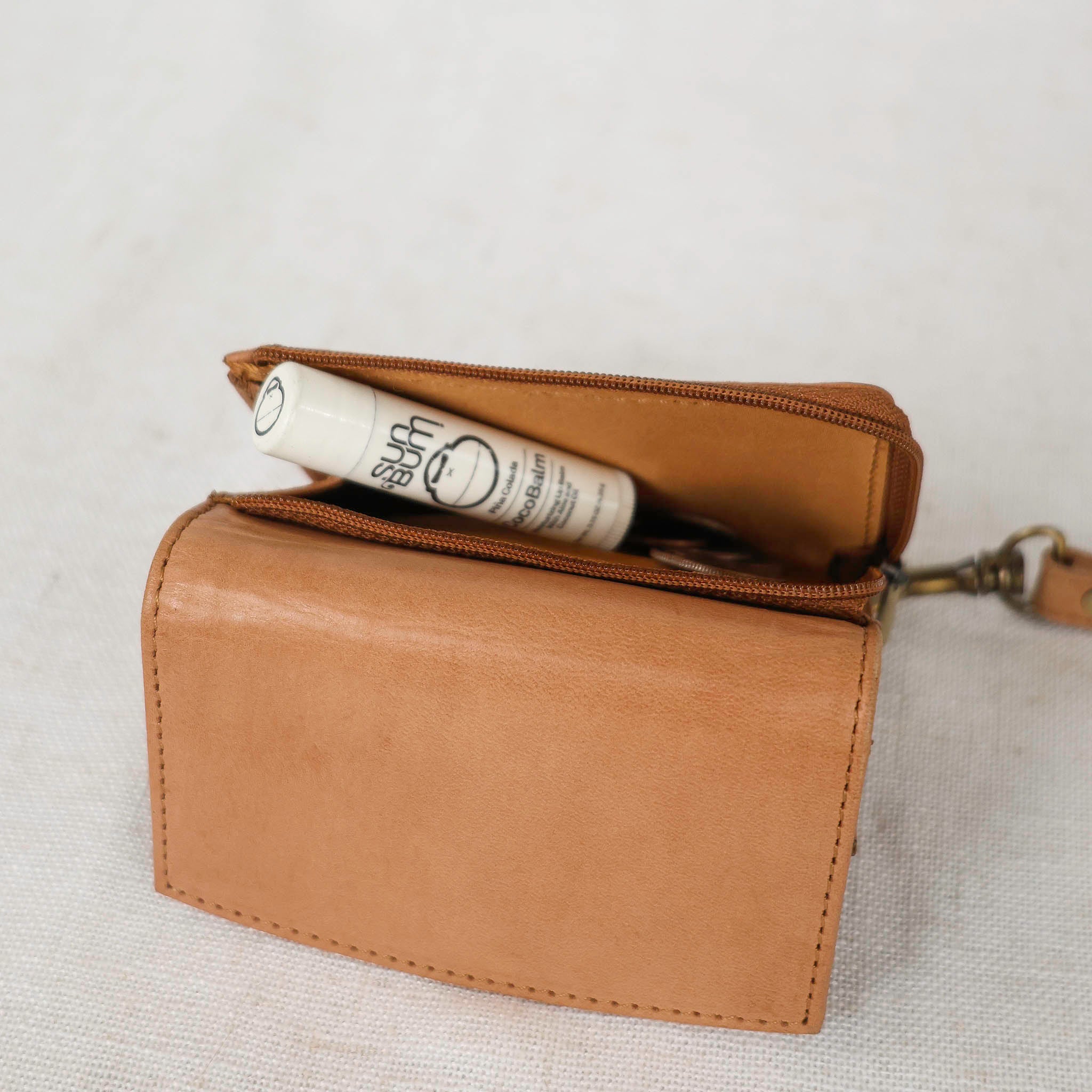 Suri Wallet being used in a casual setting, demonstrating its versatility as a stylish leather wallet women love.