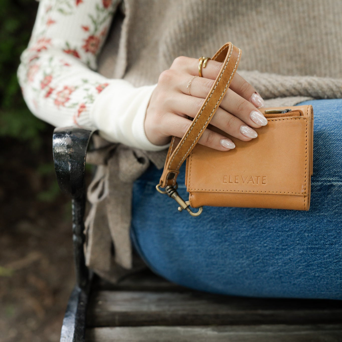 Suri Wallet with its sleek silhouette displayed alongside accessories, showcasing it as a chic leather wallet for women.