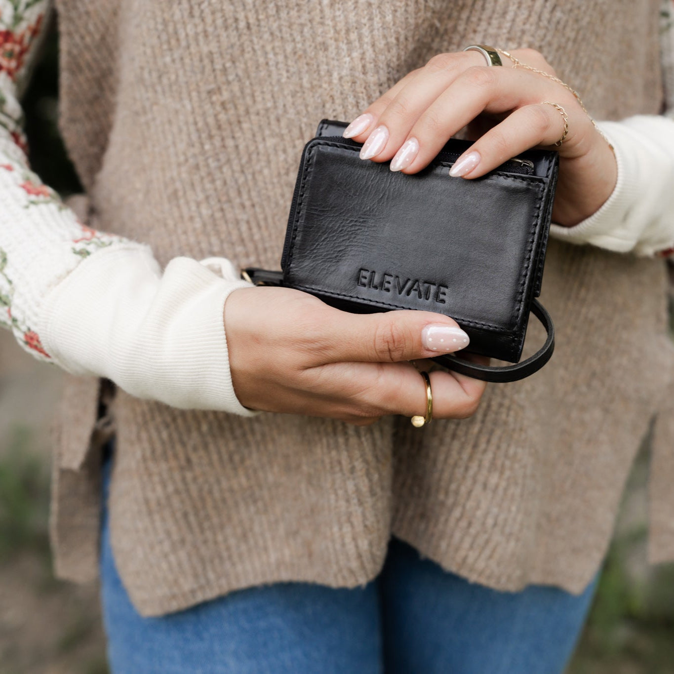 The Suri Wallet with a backdrop of accessories, illustrating its stylish appeal for women searching for a premium leather wallet.