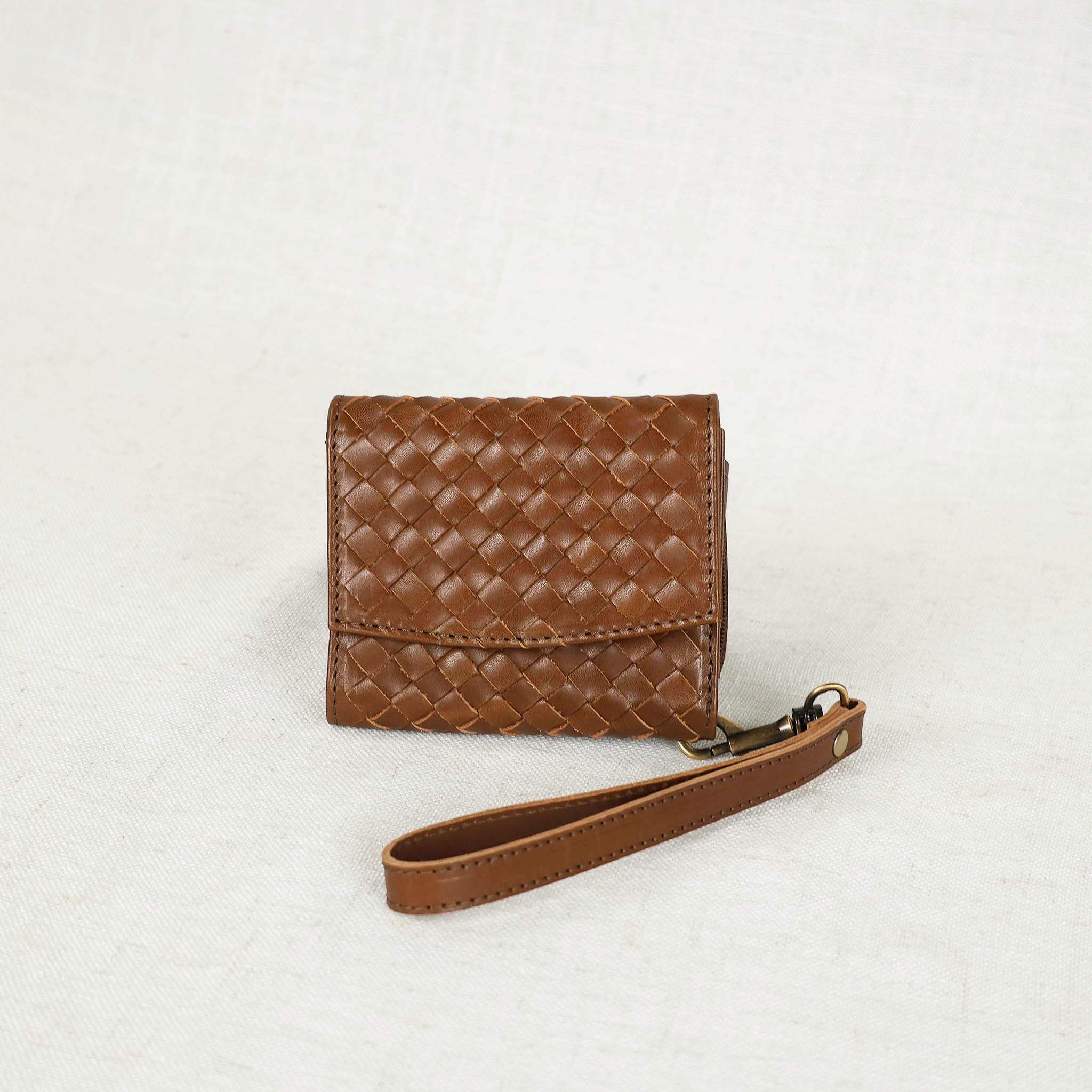 Close-up view of the Suri Woven Leather Wallet featuring its smart storage options and elegant woven texture, ideal for organizing essentials.