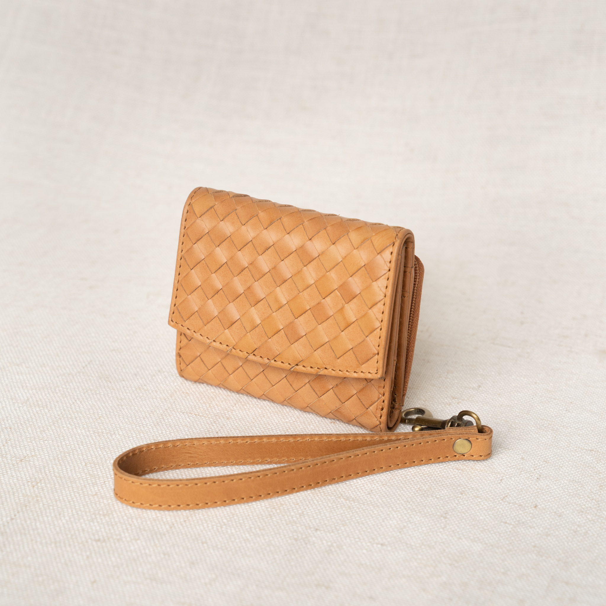 Suri Woven Leather Wallet showcasing its compact full-grain design and smart storage features.