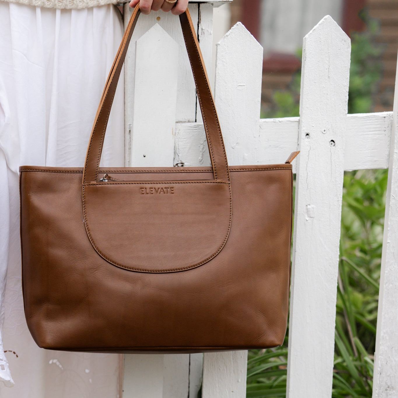 Tara Tote - Premium Leather Tote With Laptop Sleeve displayed with a laptop inside for scale and functionality.